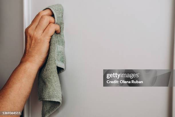 female hand cleaning closet with duster. - rag stock pictures, royalty-free photos & images