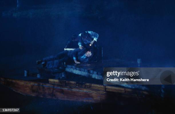 Actors Anthony Andrews and Kate Beckinsale pull Aidan Quinn from the lake in a scene from the film 'Haunted', 1995.