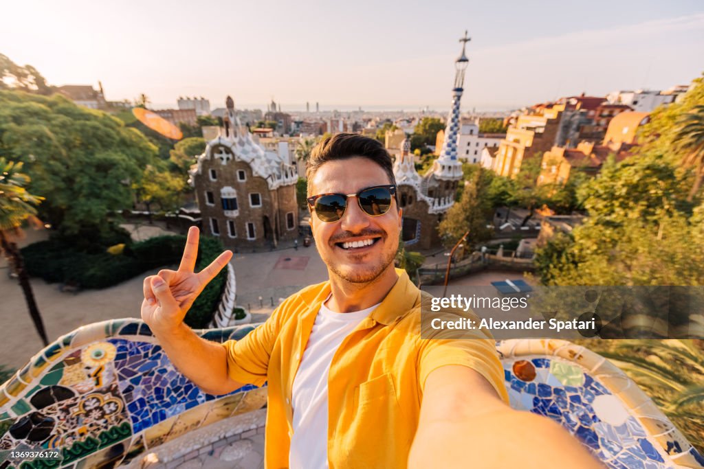 Selfie of a young smiling man in sunglasses in Barcelona, Spain