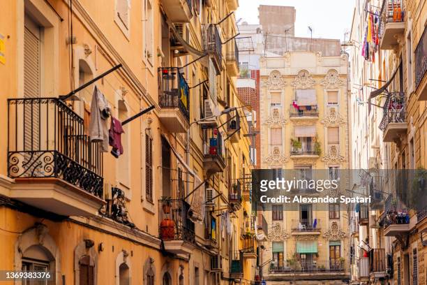 residential houses with balconies in barceloneta district, barcelona, spain - narrow stock pictures, royalty-free photos & images