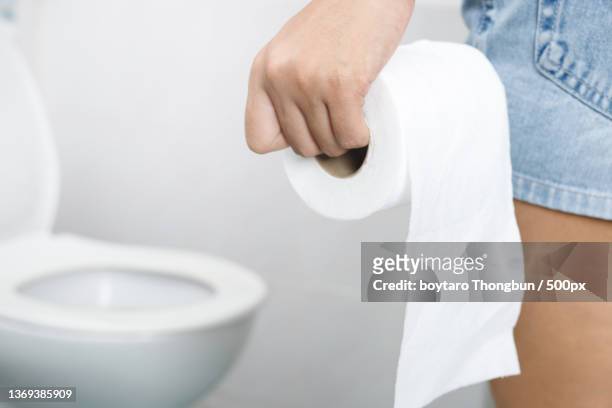 portrait of a woman suffers,midsection of woman holding toilet bowl in bathroom - woman hemorrhoids stock pictures, royalty-free photos & images