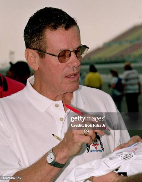 Bobby Unser signs an autograph for a fan at California Speedway, September 26, 1997 in Fontana, California.