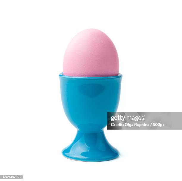 a pink easter egg on a stand is isolated on a white background - egg cup stock pictures, royalty-free photos & images