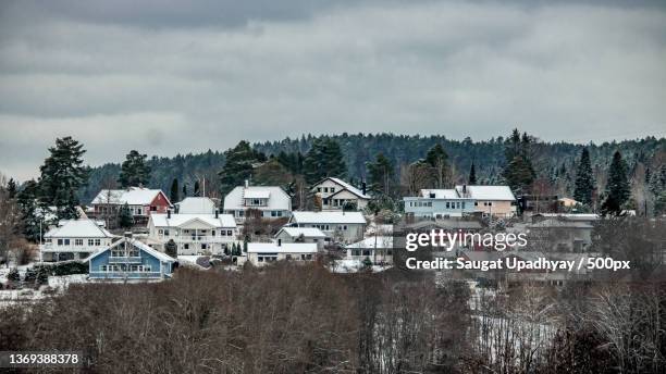 snow in the sight,high angle view of townscape against sky during winter,halden,norway - halden norway stock pictures, royalty-free photos & images