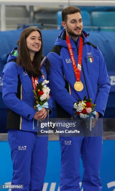 Gold medallists Stefania Constantini and Amos Mosaner of Team Italy pose with their medals during the Curling Mixed Doubles medal ceremony on Day 4...