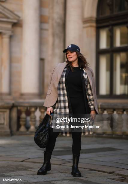 Dayami Candebat is seen wearing Kaffe curve long flanell, Ducie black boots, big Bottega Veneta Jodie black leather bag, Prada black shades, cap and...