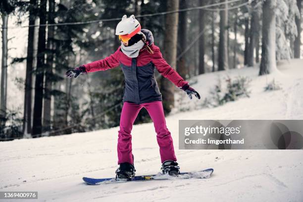 teenage girl enjoying snowboard on winter day - snowboard imagens e fotografias de stock