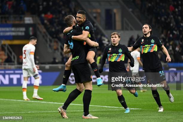 Edin Dzeko of FC Internazionale celebrates with Alexis Sanchez after scoring the opening goal during the Coppa Italia match between FC Internazionale...