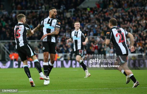 Jamaal Lascelles, Kieran Trippier and Ryan Fraser celebrate their side's first goal, an own goal by Mason Holgate of Everton during the Premier...