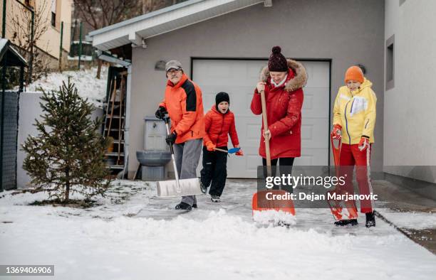 family cleaning snow - grandfather child snow winter stock pictures, royalty-free photos & images