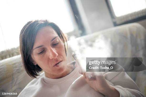 junge frau mit e-zigarette - dampfen - e zigarette stock-fotos und bilder
