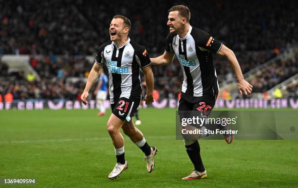 Ryan Fraser of Newcastle United celebrates with team mate Chris Wood after scoring their sides second goal during the Premier League match between...