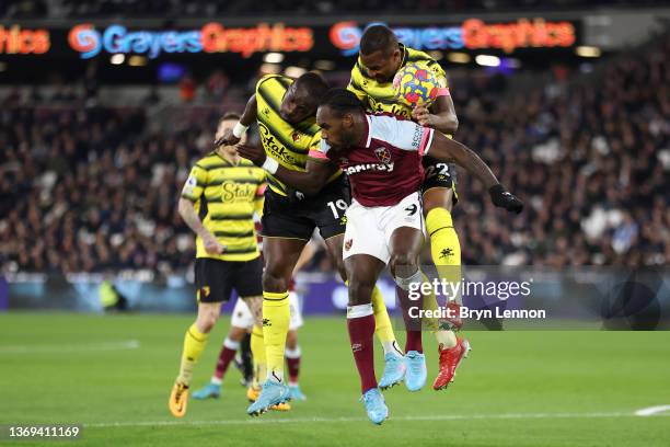 Michail Antonio of West Ham United competes for a header with Moussa Sissoko and Samir of Watford FC during the Premier League match between West Ham...