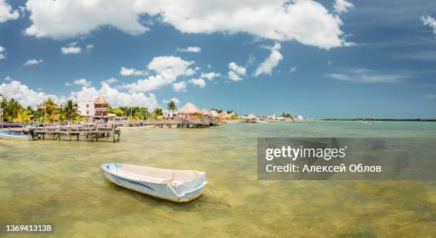 landscape overlooking the rio lagartos. fishing boats are moored to the shore.. yucatan, mexico - fishing village stock pictures, royalty-free photos & images