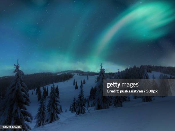 winter wonderland,scenic view of snow covered mountains against sky at night,ciceu,harghita county,romania - transylvania stock pictures, royalty-free photos & images