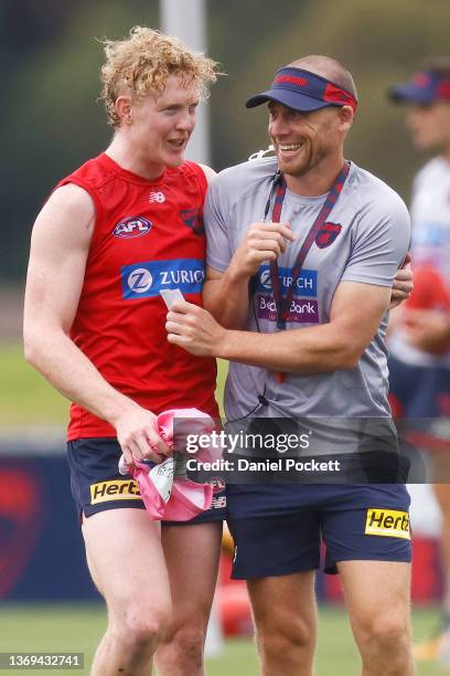 Clayton Oliver of the Demons and Demons head coach Simon Goodwin share a laugh during a Melbourne Demons AFL training session at Casey Fields on...