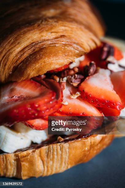 delicious breakfast with fresh croissants with chocolate, strawberry and banana. - filling imagens e fotografias de stock