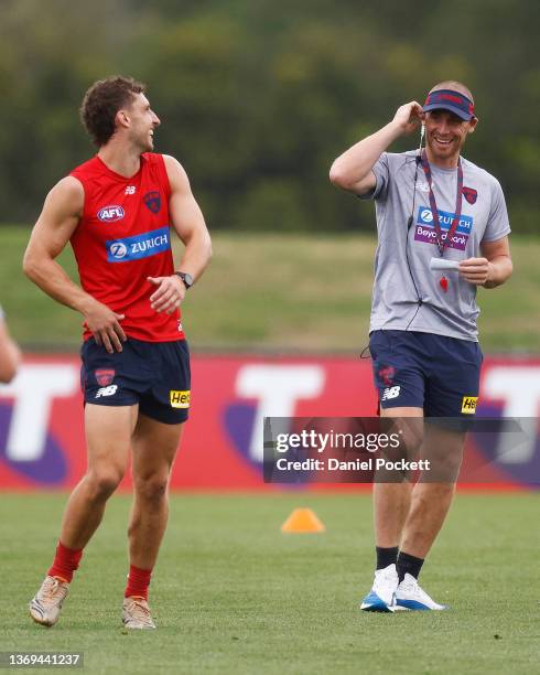 Luke Dunstan of the Demons and Demons head coach Simon Goodwin chat during a Melbourne Demons AFL training session at Casey Fields on February 09,...