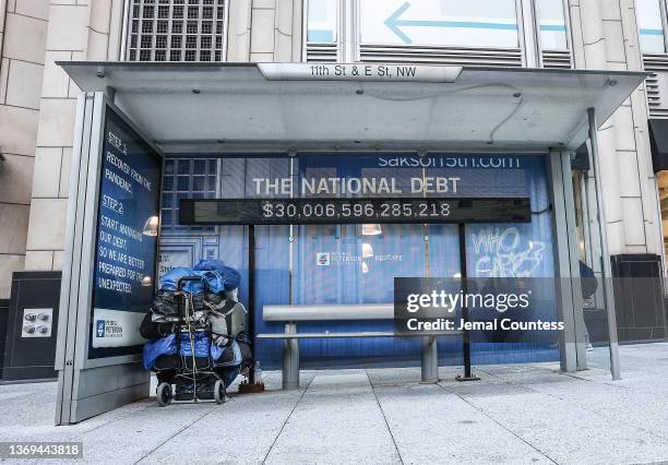 Peterson Foundation billboard displaying the national debt is pictured on 11th Street in downtown Washington DC on February 08, 2022 in Washington,...