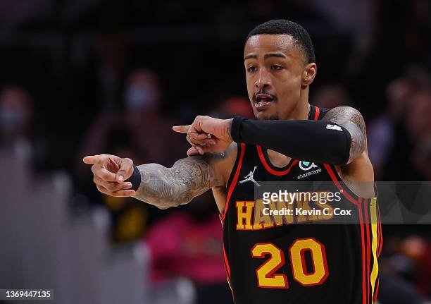 John Collins of the Atlanta Hawks reacts after hitting a three-point basket against the Indiana Pacers during the first half at State Farm Arena on...