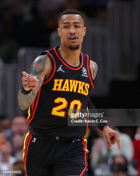 John Collins of the Atlanta Hawks reacts after dunking against the Indiana Pacers during the first half at State Farm Arena on February 08, 2022 in...