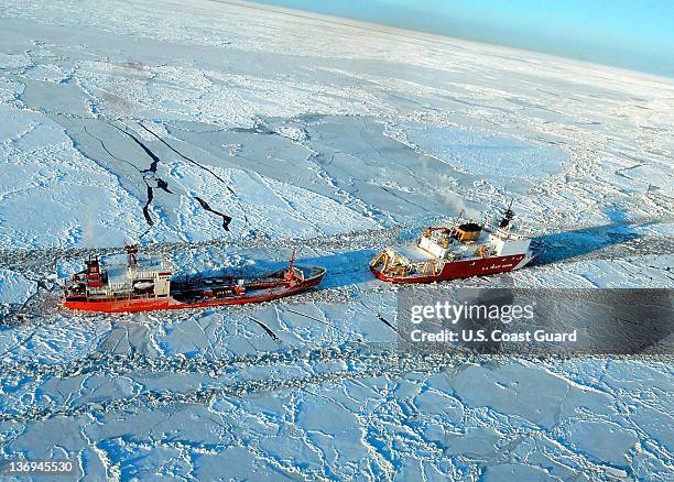 In this photo provided by the U.S. Coast Guard, the Russian tanker Renda powers toward Nome, Alaska with the U.S. Coast Guard Cutter Healy's...