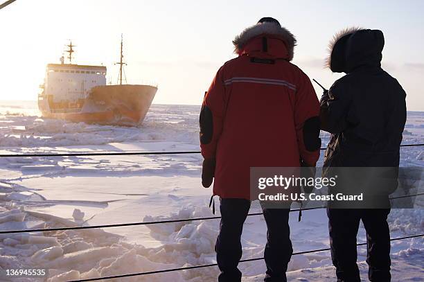 In this photo provided by the U.S. Coast Guard, crewmembers of the U.S. Coast Guard Cutter Healy observe the Russian tanker vessel Renda as it...