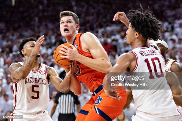 Walker Kessler of the Auburn Tigers works to go up for a shot in overtime against Au'Diese Toney and Jaylin Williams of the Arkansas Razorbacks at...