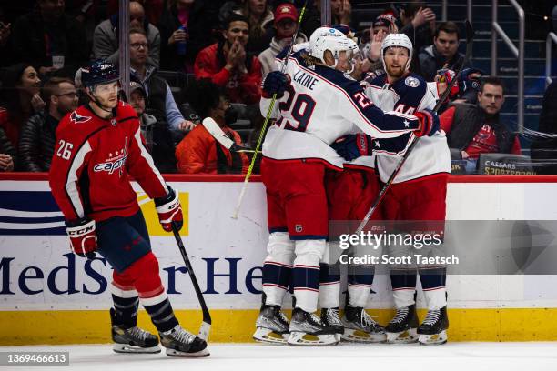 Boone Jenner of the Columbus Blue Jackets celebrates with teammates after scoring a goal against the Washington Capitals during the third period of...