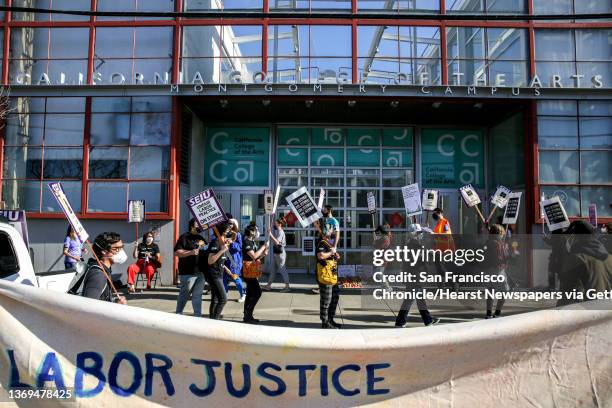 California College of the Arts' staff Matt Kennedy, center, strikes in protest of the school's unfair labor practices outside of its building in San...