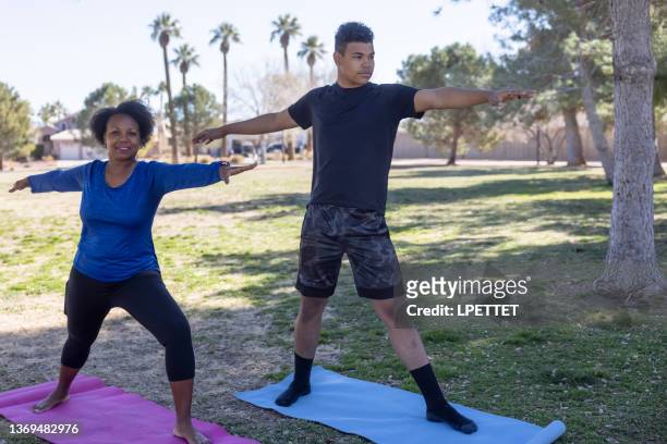 yoga at the park - teenager yoga stock pictures, royalty-free photos & images