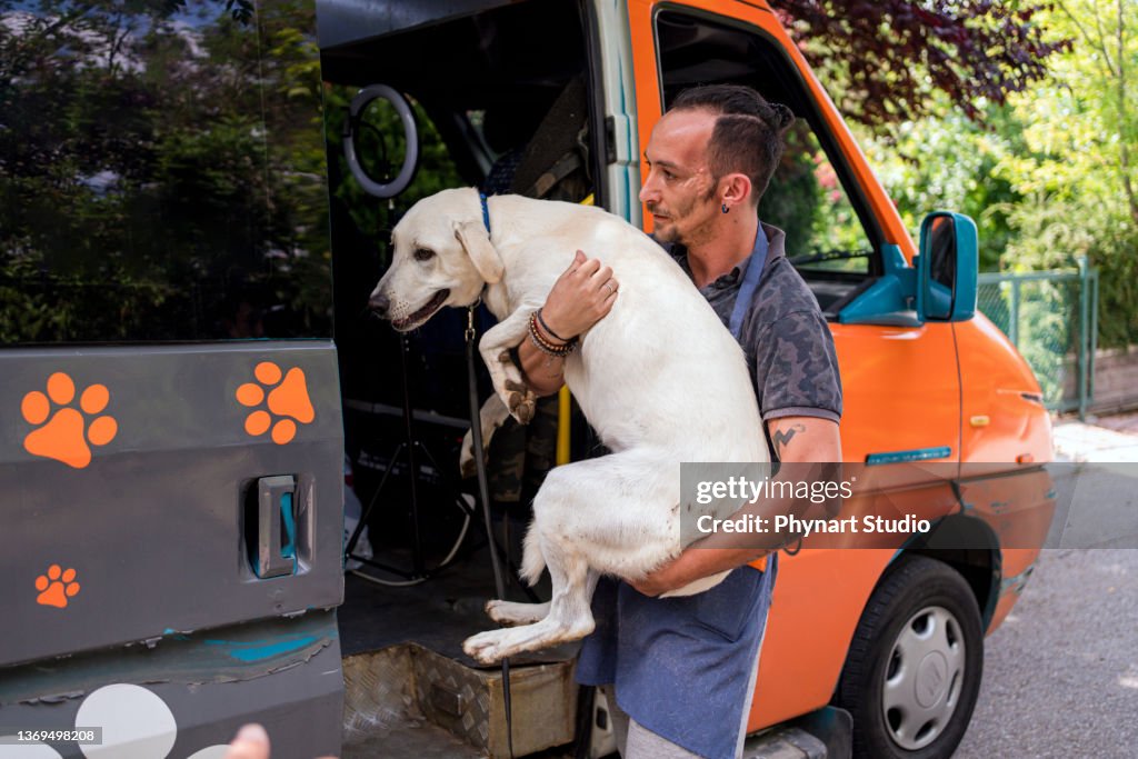 Grooming carrying the stray dog in his lap