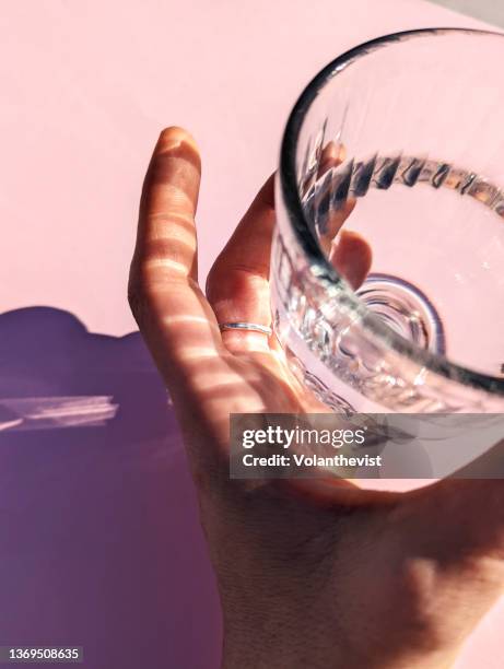 glass with water and hard shadow - drinking water glass stock pictures, royalty-free photos & images