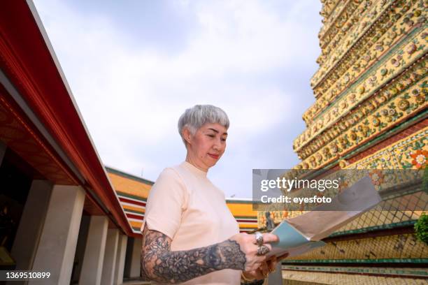 senior woman is solo traveller. - old woman tattoos stock pictures, royalty-free photos & images