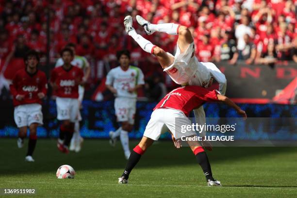 Akira Takeuchi of Nagoya Grampus and Naohiro Takahara of Urawa Red Diamonds compete for the ball during the J.League J1 match between Urawa Red...