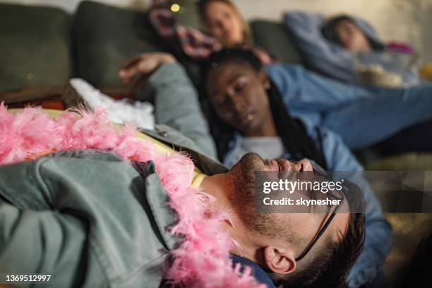 drunk friends fell asleep after party at home. - passed out drunk stockfoto's en -beelden