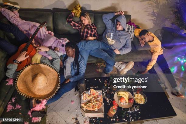 obige ansicht von betrunkenen freunden, die nach der party zu hause schlafen. - messy house after party stock-fotos und bilder
