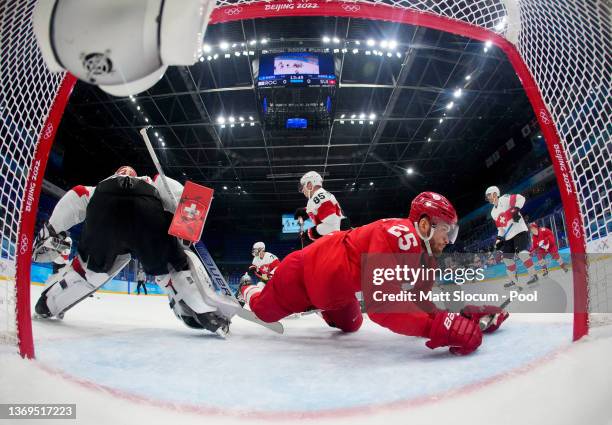 Mikhail Grigorenko of Team ROC fails to score over Reto Berra, goaltender of Team Switzerland in the first period during the Men's Preliminary Round...