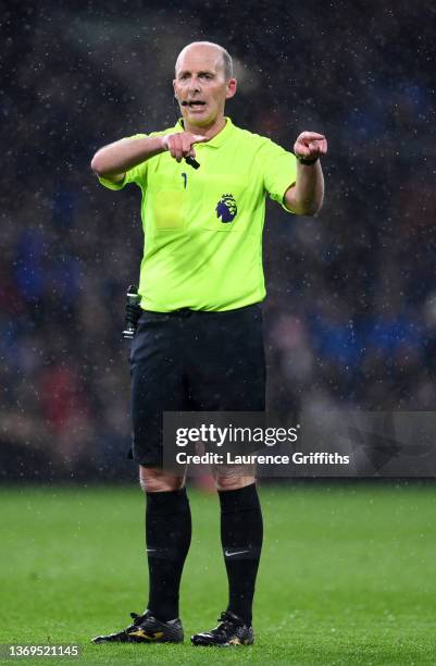 Referee, Mike Dean instructs the players during the Premier League match between Burnley and Manchester United at Turf Moor on February 08, 2022 in...