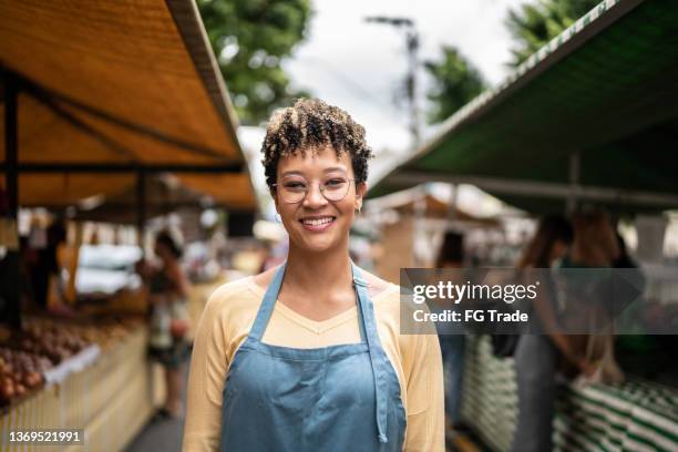 portrait of a seller at a street market - saleswoman stock pictures, royalty-free photos & images