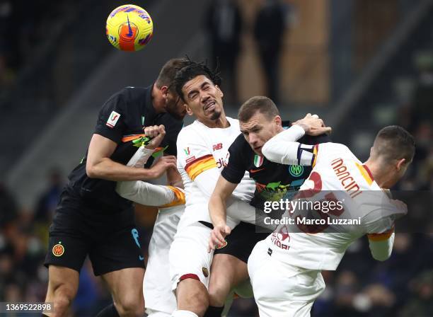 Edin Dzeko of FC Internazionale competes for the ball with Chris Smalling and Gianluca Mancini of AS Roma during the Coppa Italia match between FC...