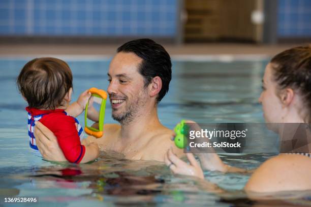 happy to help - baby swimmer stock pictures, royalty-free photos & images