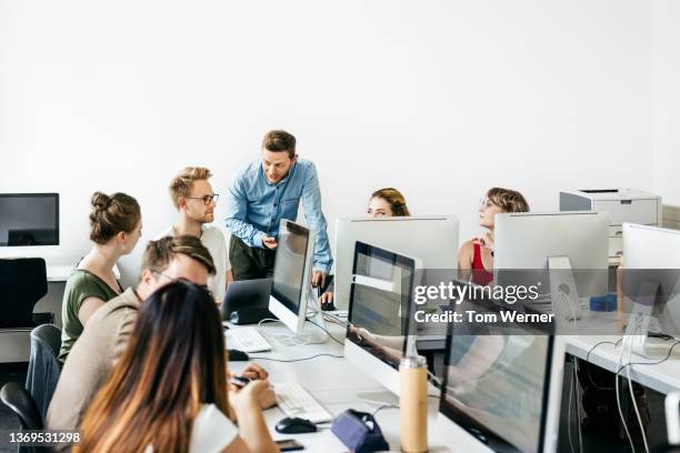 teacher talking to student about task during seminar - seminary stock pictures, royalty-free photos & images