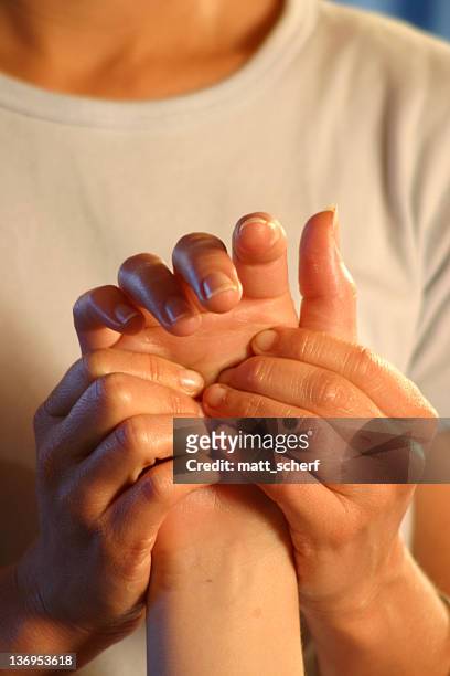 closeup of woman masseuse massaging man's hand - hand massage stock pictures, royalty-free photos & images