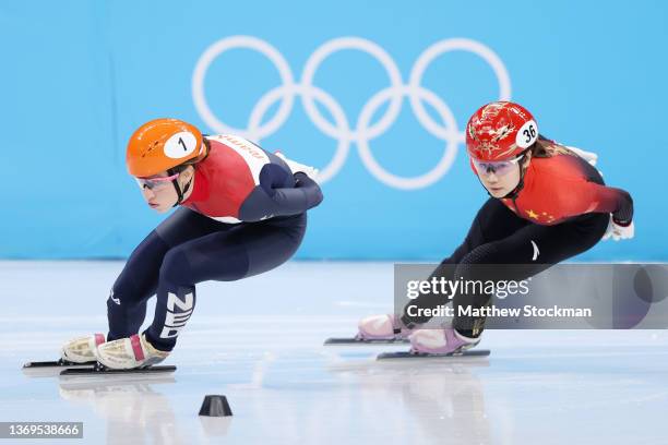 Suzanne Schulting of Team Netherlands and Yutong Han of Team China compete during the Women's 1000m Heats on day five of the Beijing 2022 Winter...