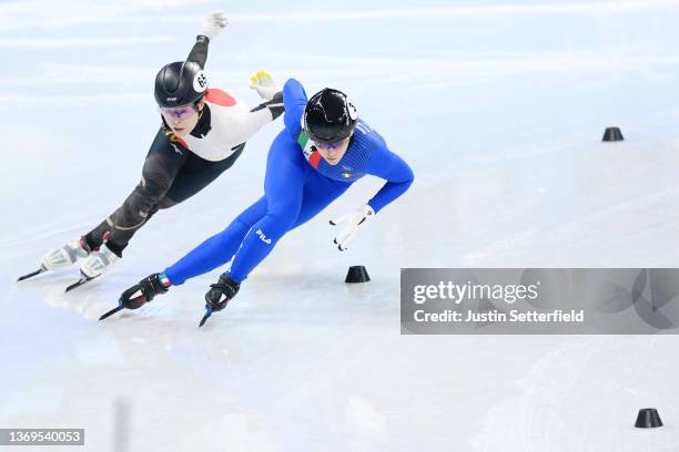 Sumire Kikuchi of Team Japan and Arianna Fontana of Team Italy compete during the Women's 1000m Heats on day five of the Beijing 2022 Winter Olympic...