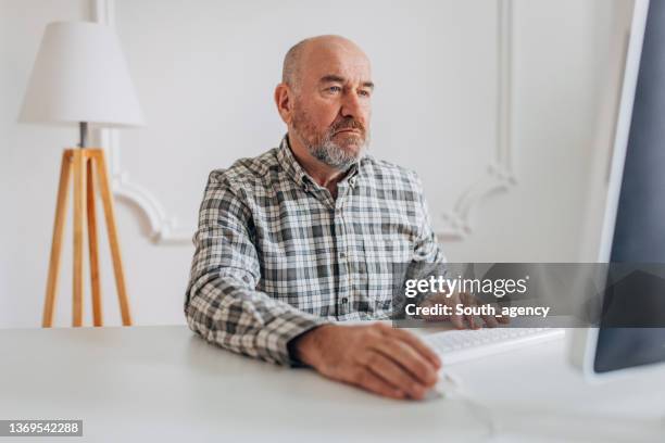 mature man using computer - hairless mouse stock pictures, royalty-free photos & images
