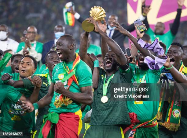 Senegal captain KALIDOU KOULIBALY holds the AFCON trophy as his team celebrate winning the Africa Cup of Nations 2021 final match between Senegal and...