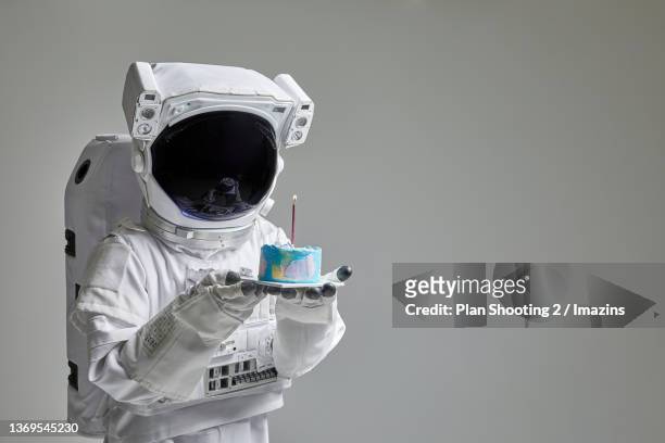an astronaut with a cake - astronaut potrait stock pictures, royalty-free photos & images