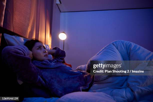 a woman getting stressed by noise between apartment - korea apartment woman stock-fotos und bilder